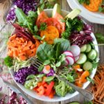 colourful green salad in bowl with chopped vegetables