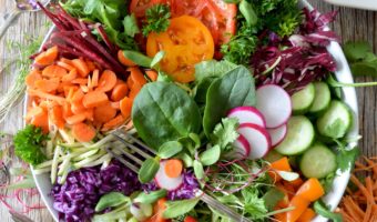 colourful green salad in bowl with chopped vegetables